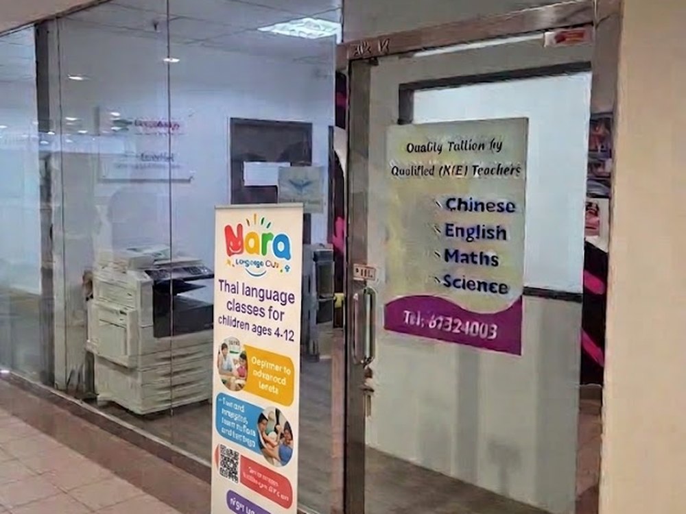 The Nara Language Club entrance on the second floor of Balmoral Plaza, with a Thai classes banner outside the glass door